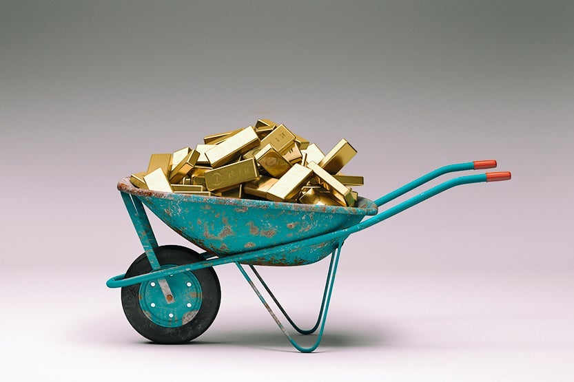 Rusty wheelbarrow full of gold bars