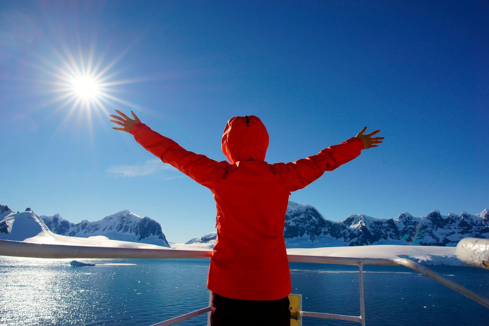 Woman watching the glacier in Antarctica from the boat