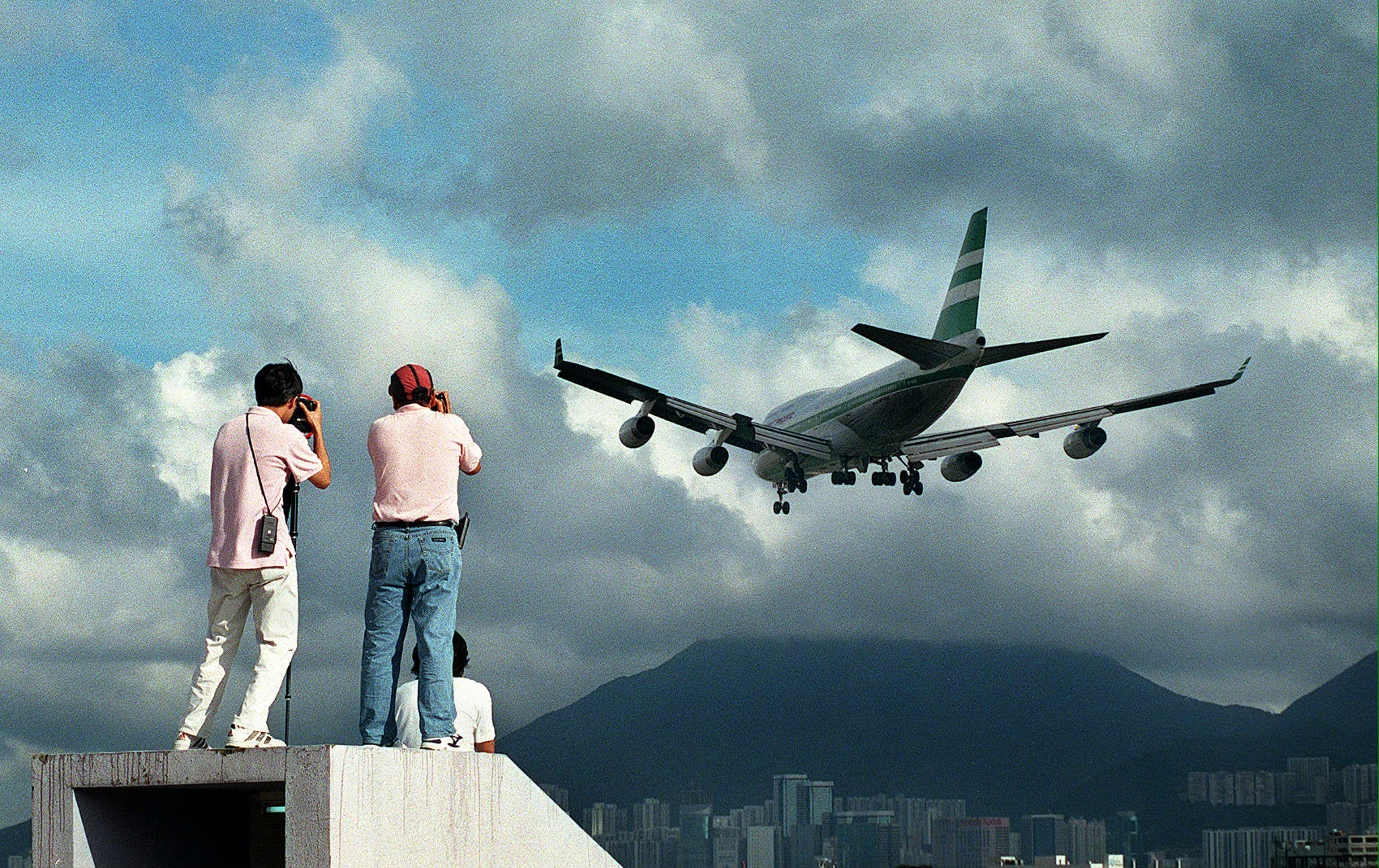 Two people climb onto a rooftop in Kowloon City 13