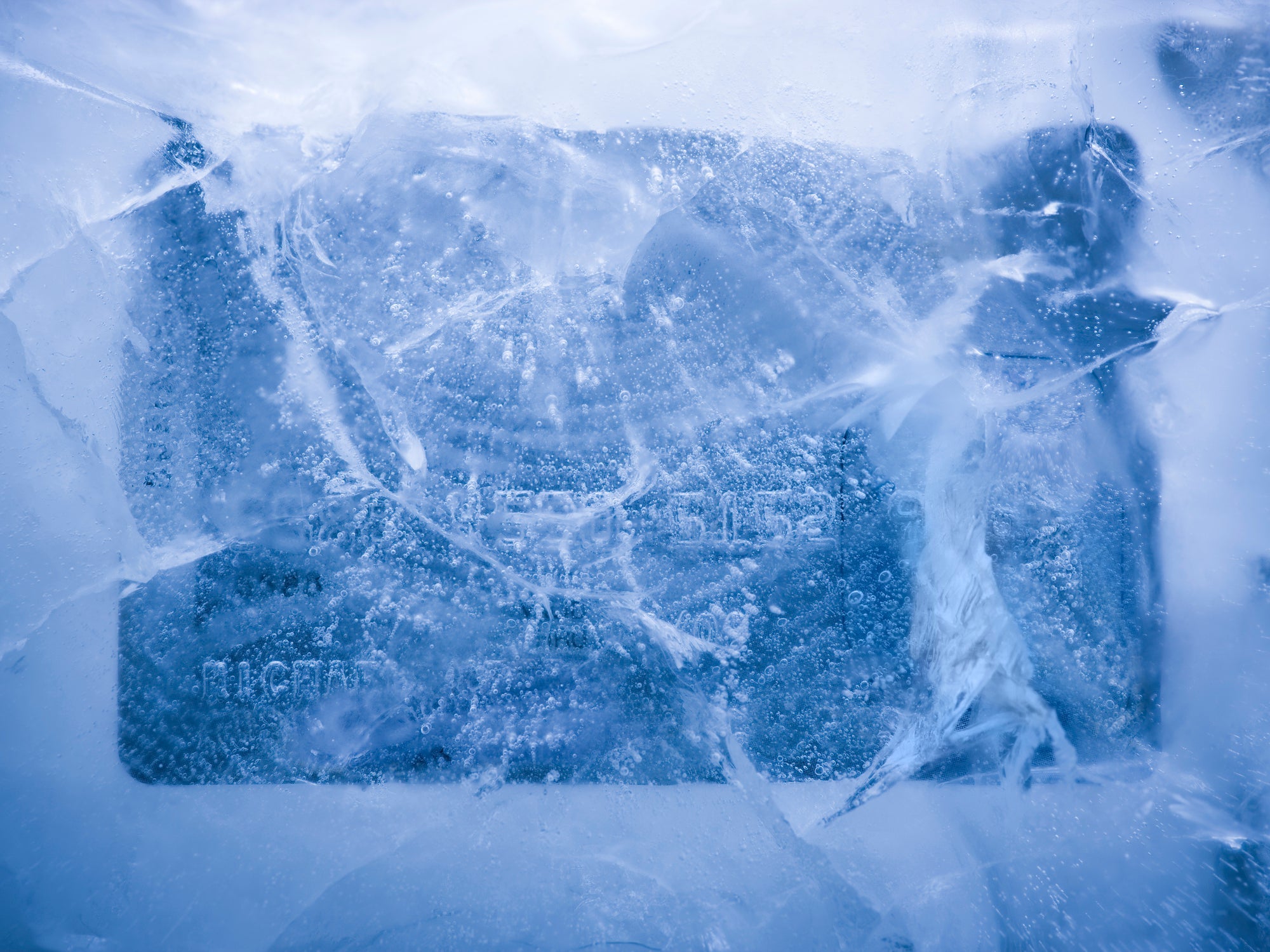 credit card frozen in a solid block of ice