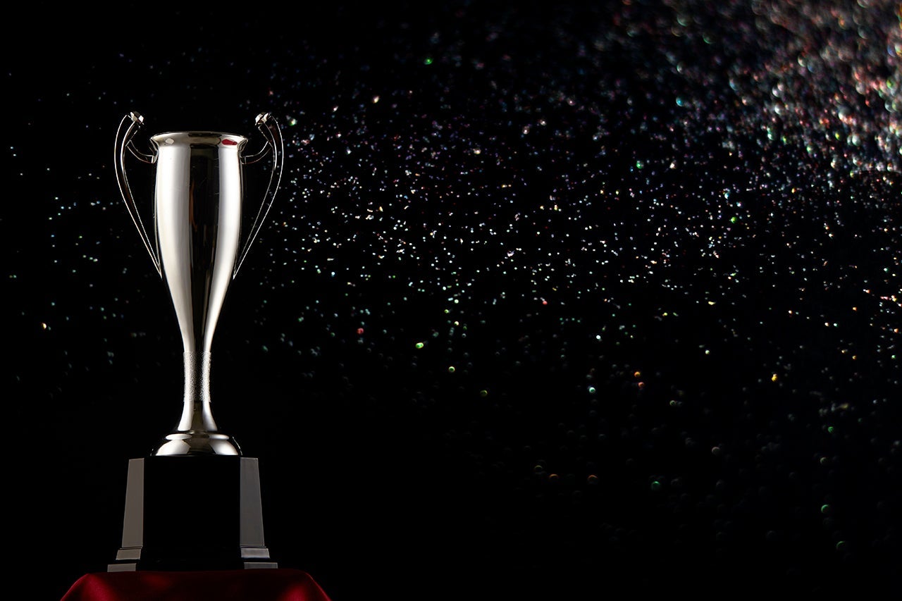 Close-Up Of Trophy Against Black Background