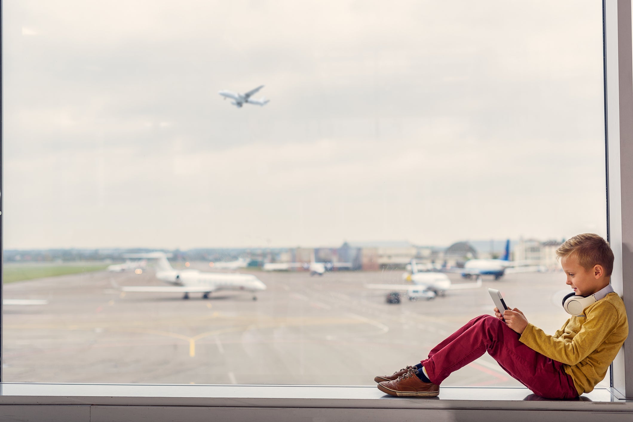 Little boy sitting at airport