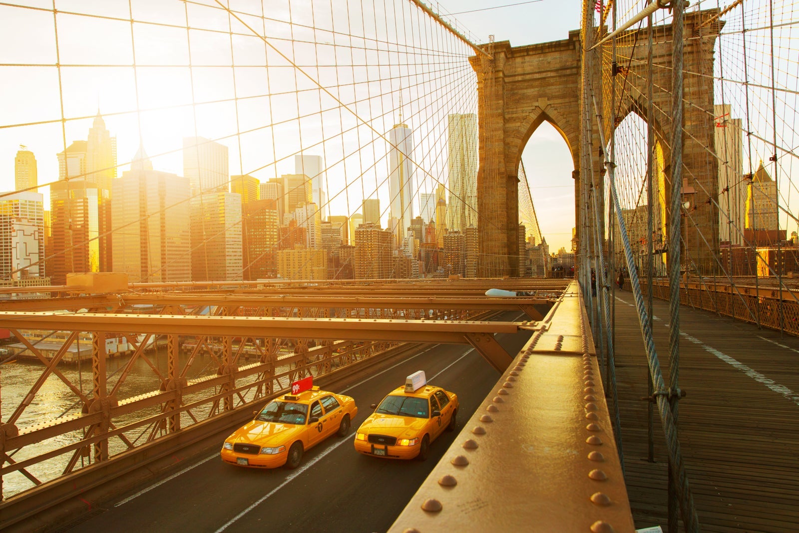 Taxis on The Brooklyn Bridge at sunset in New York