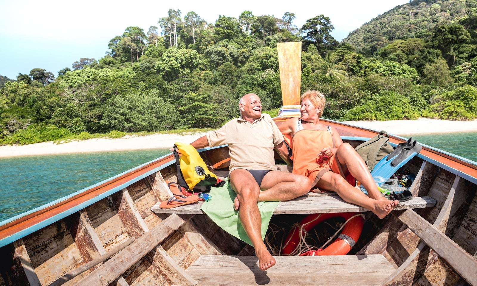Smiling Couple Sitting In Boat On Sea