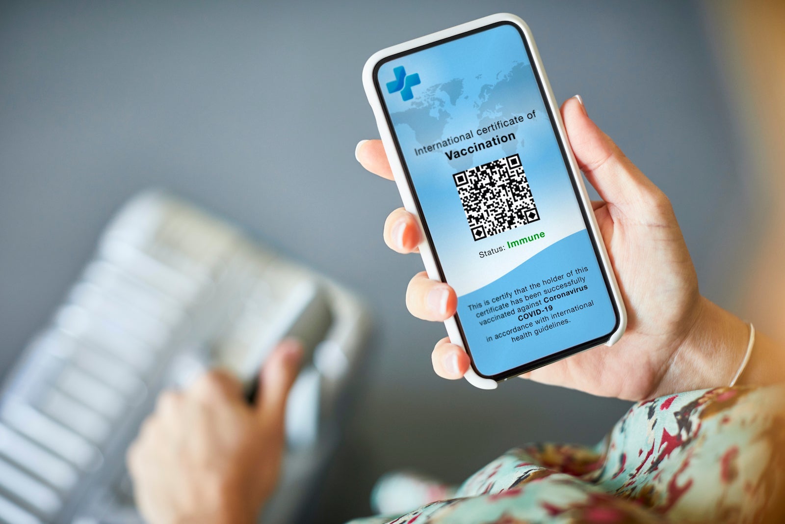 Woman Checking Covid-19 Vaccine Passport On Cellphone