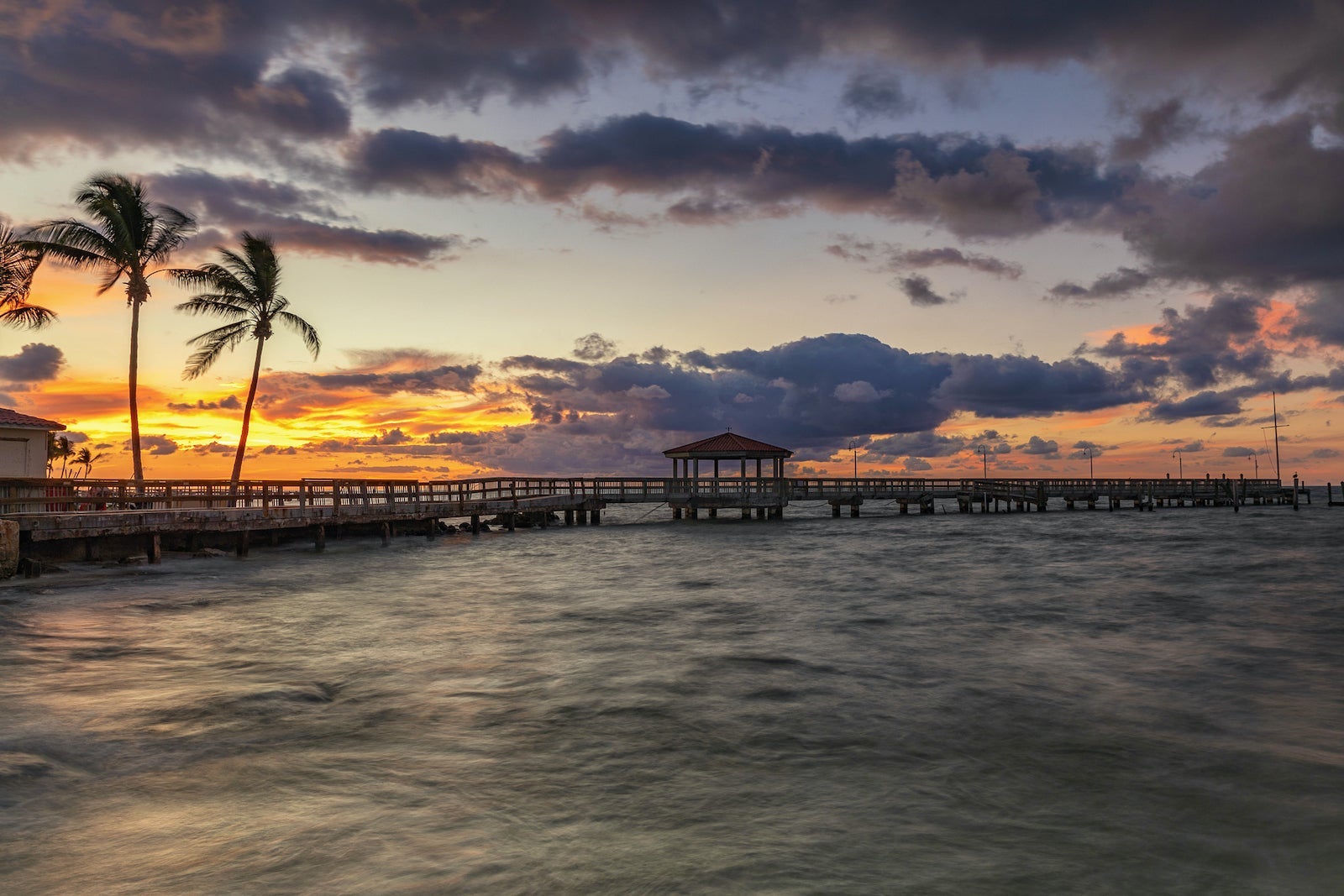 Silhouette Pier Over Sea Against Sky During Sunset