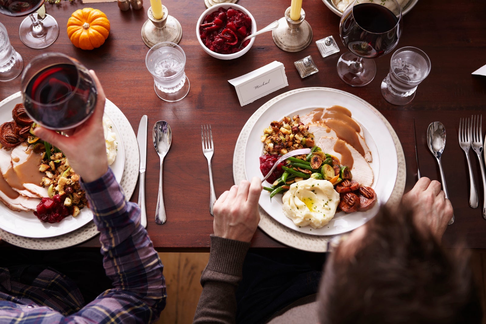 Overhead of two men eating holiday meal