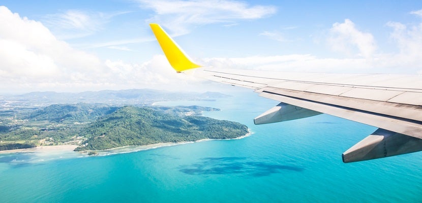 Airplane wing ocean island featured 2 shutterstock 262466249