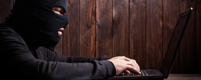 Scammer computer online wood background banner shutterstock 201595700