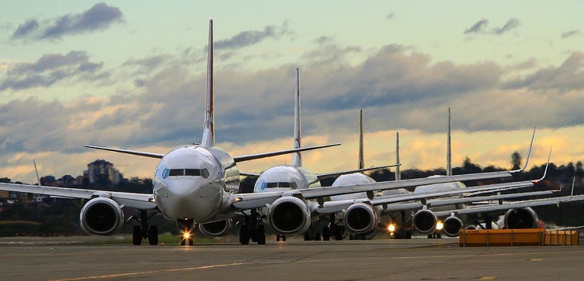 airplanes-in-line-on-runway-full-shutterstock-198700100