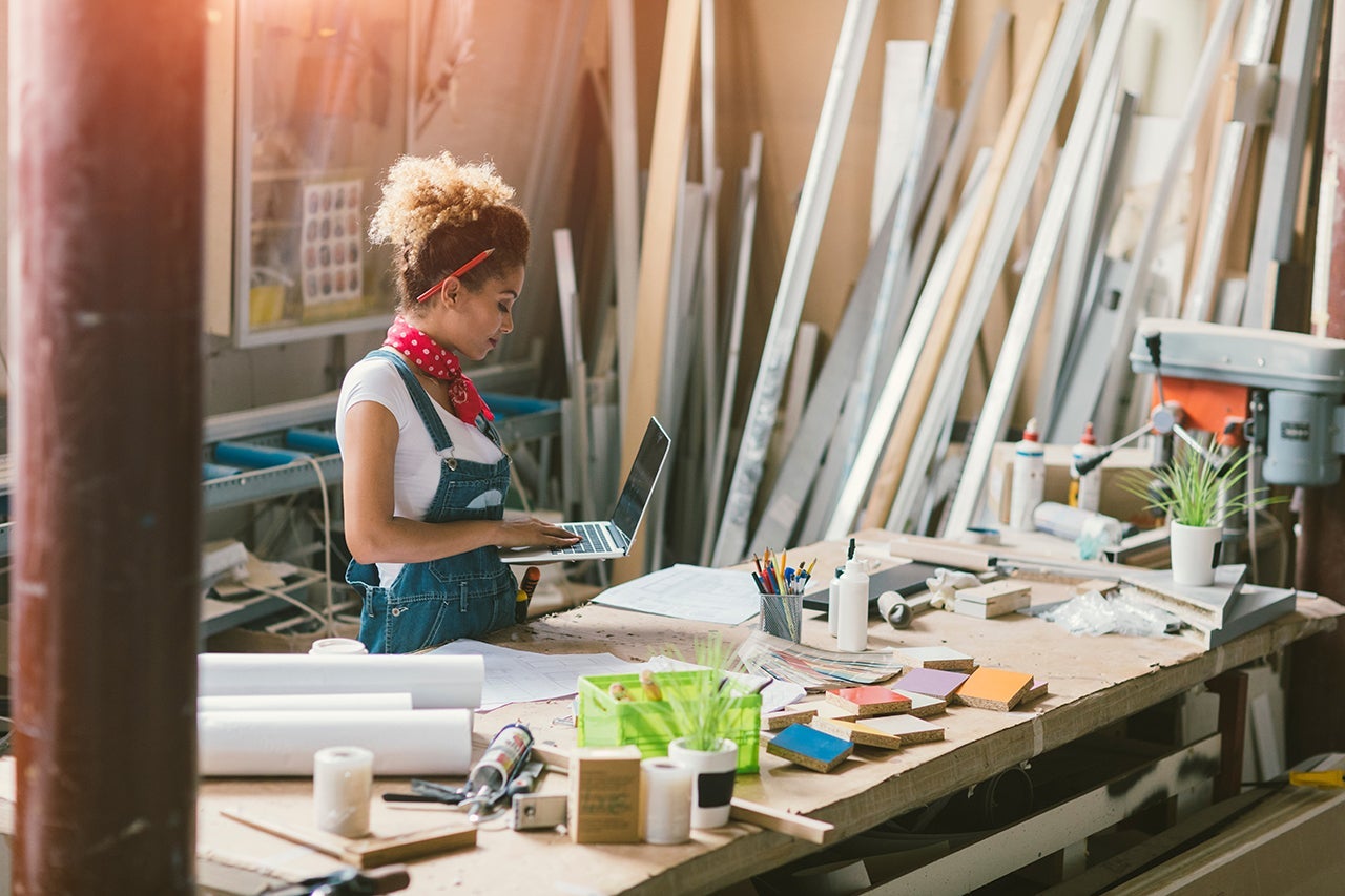 Latina Carpenter Standing In Her Workshop