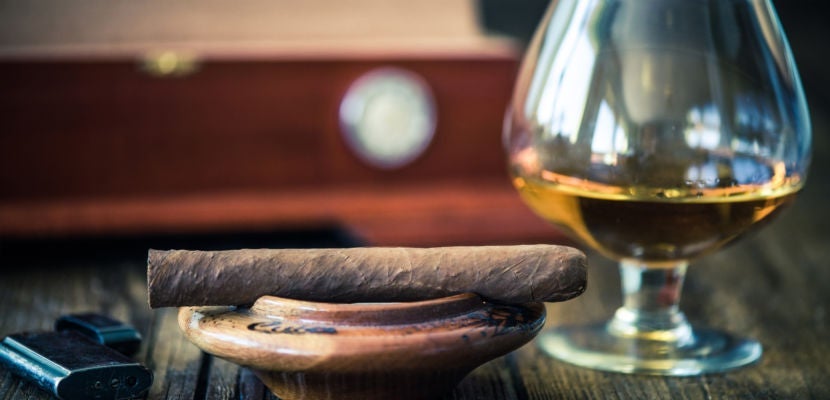 cuban cigar and humidor in background