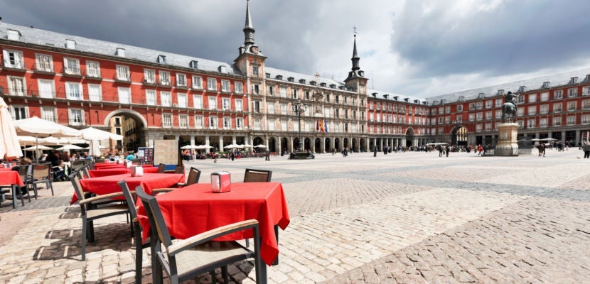 Cafe tables with red tableclothes in Plaza Mayor. Madrid.