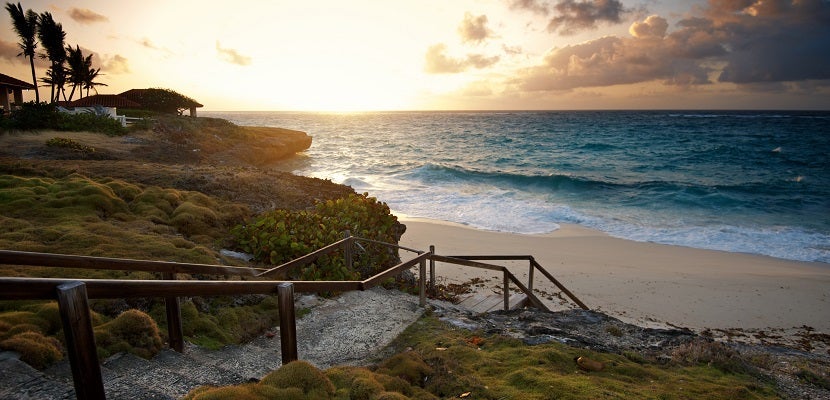 Sunrise over the sea on small secluded beach