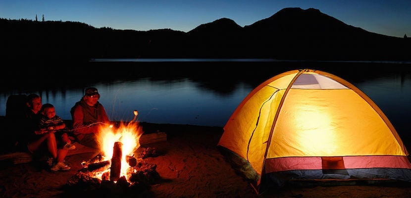 Family roasting marshmallows over a campfire