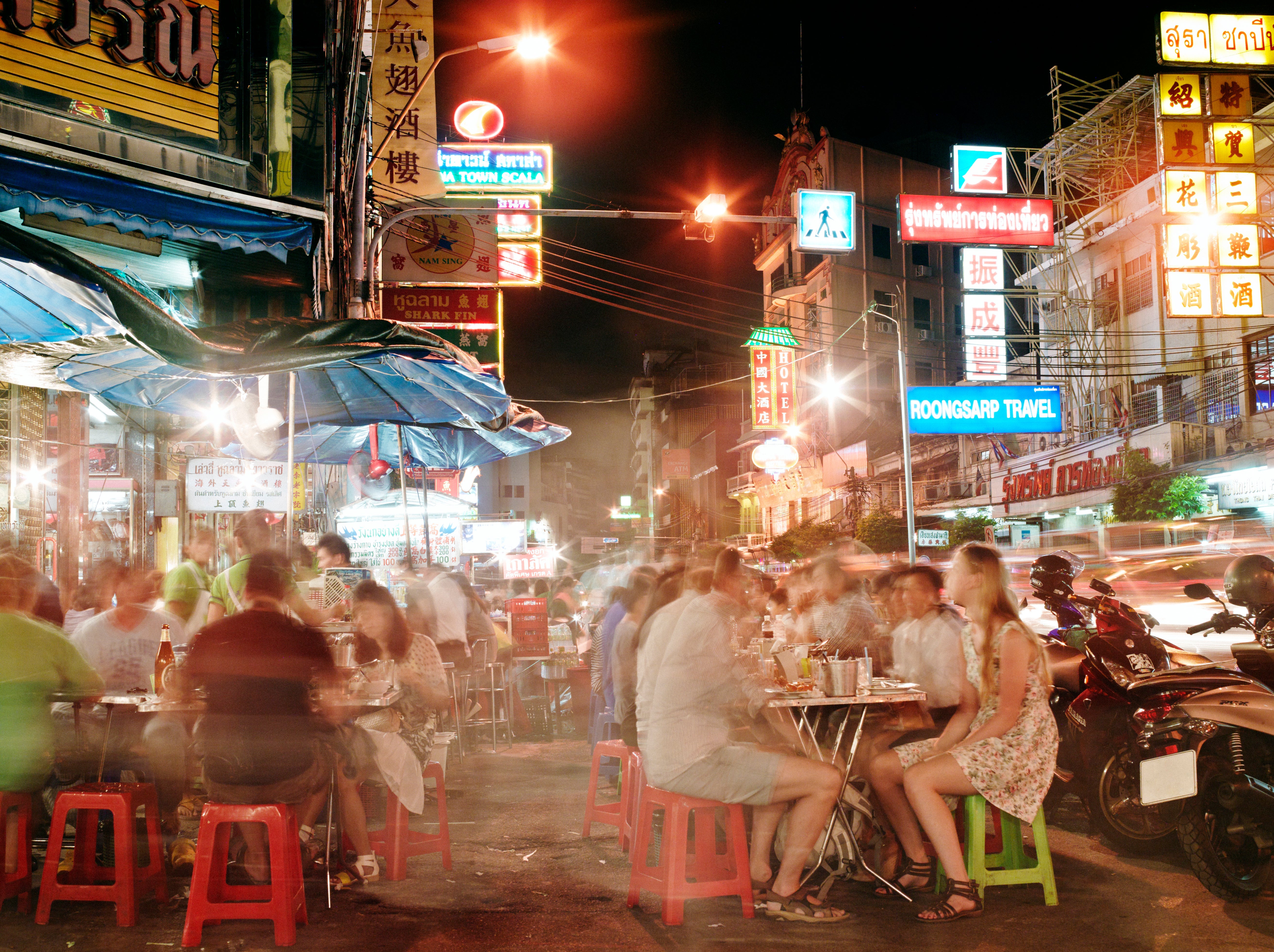 People dining outside at food stalls at night