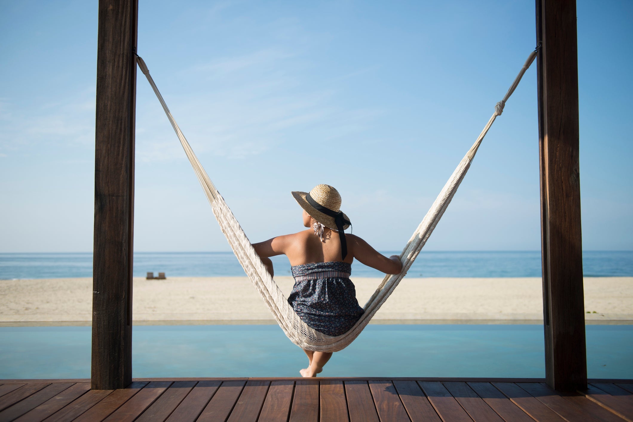 Woman sitting on a hamock at a small hotel in the coast of Oaxaca, Mexico.
