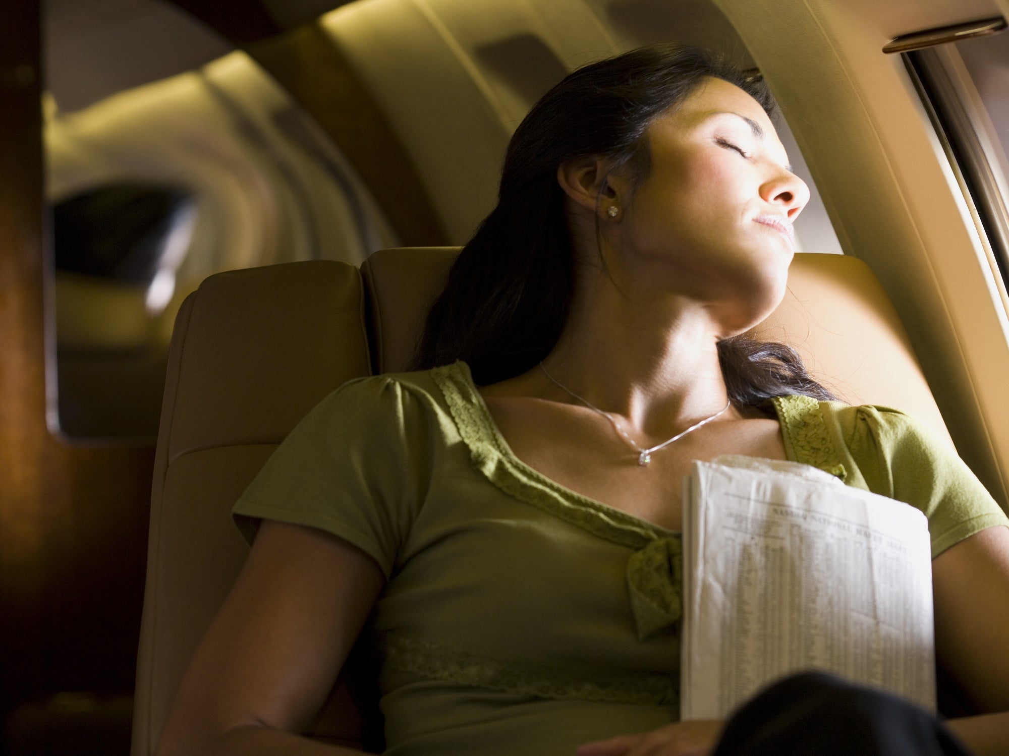 A woman sleeping in an airplane