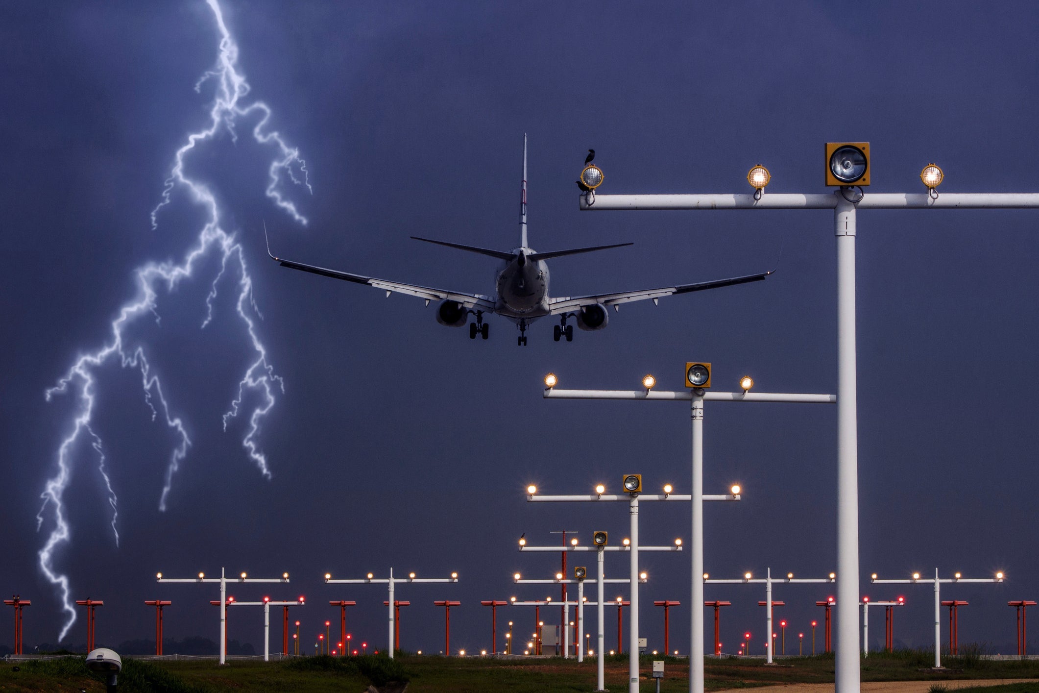 View Of Airplane Over Runway In Stormy Weather
