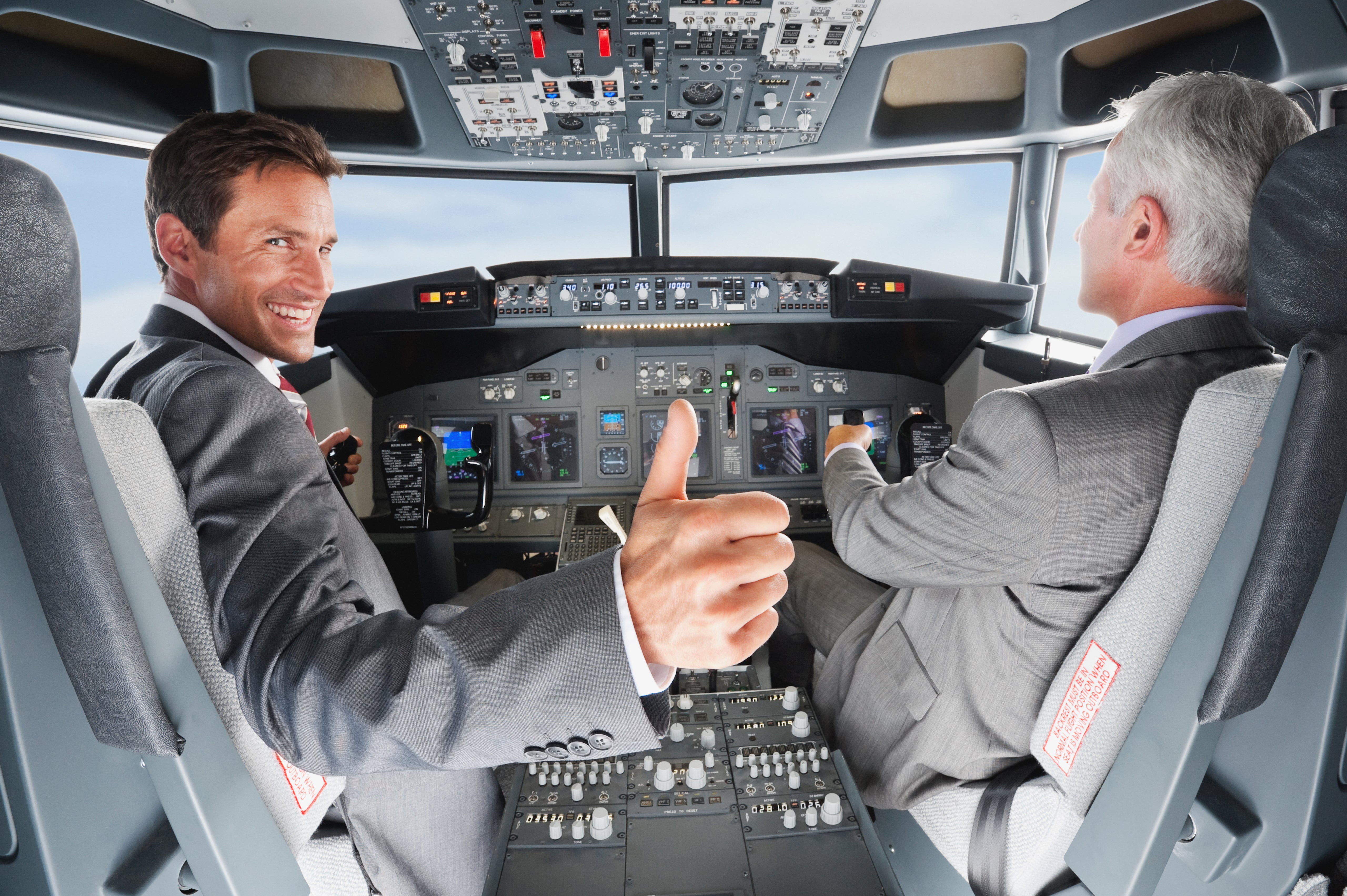 Pilot and co-pilot piloting airplane from airplane cockpit
