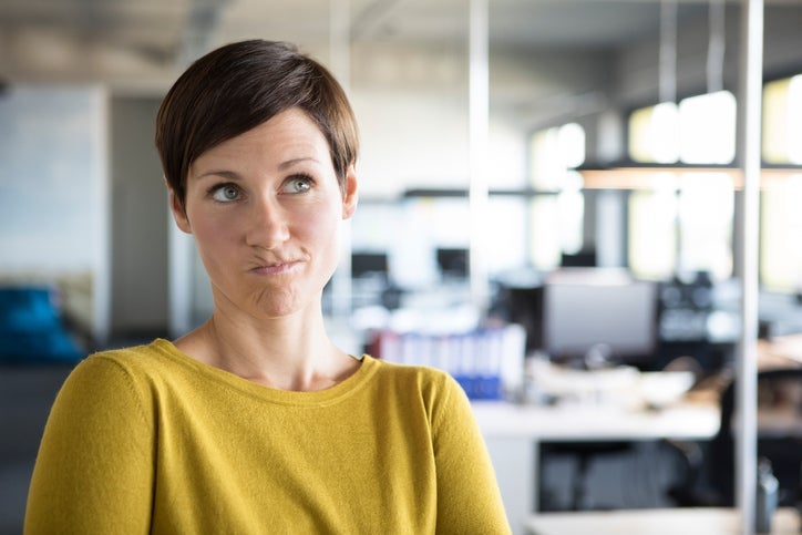 Businesswoman in office thinking