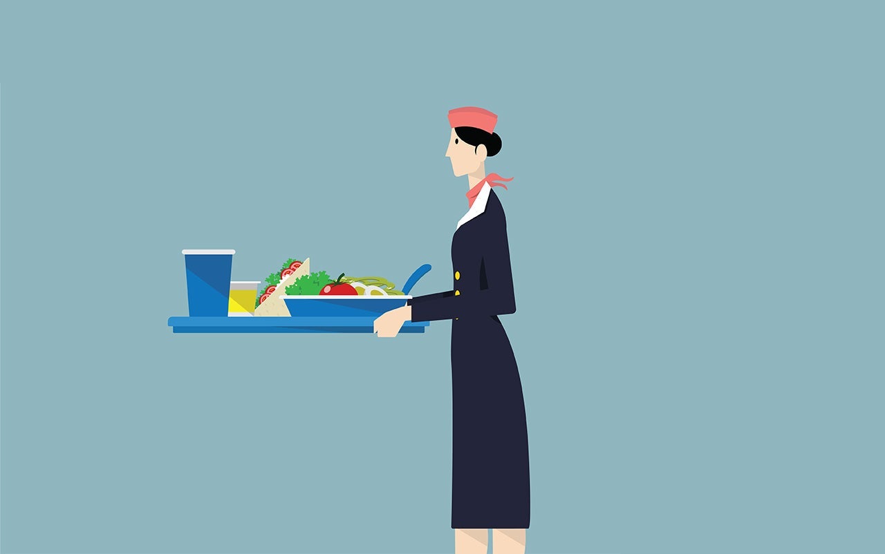 Airline hostess serving food.