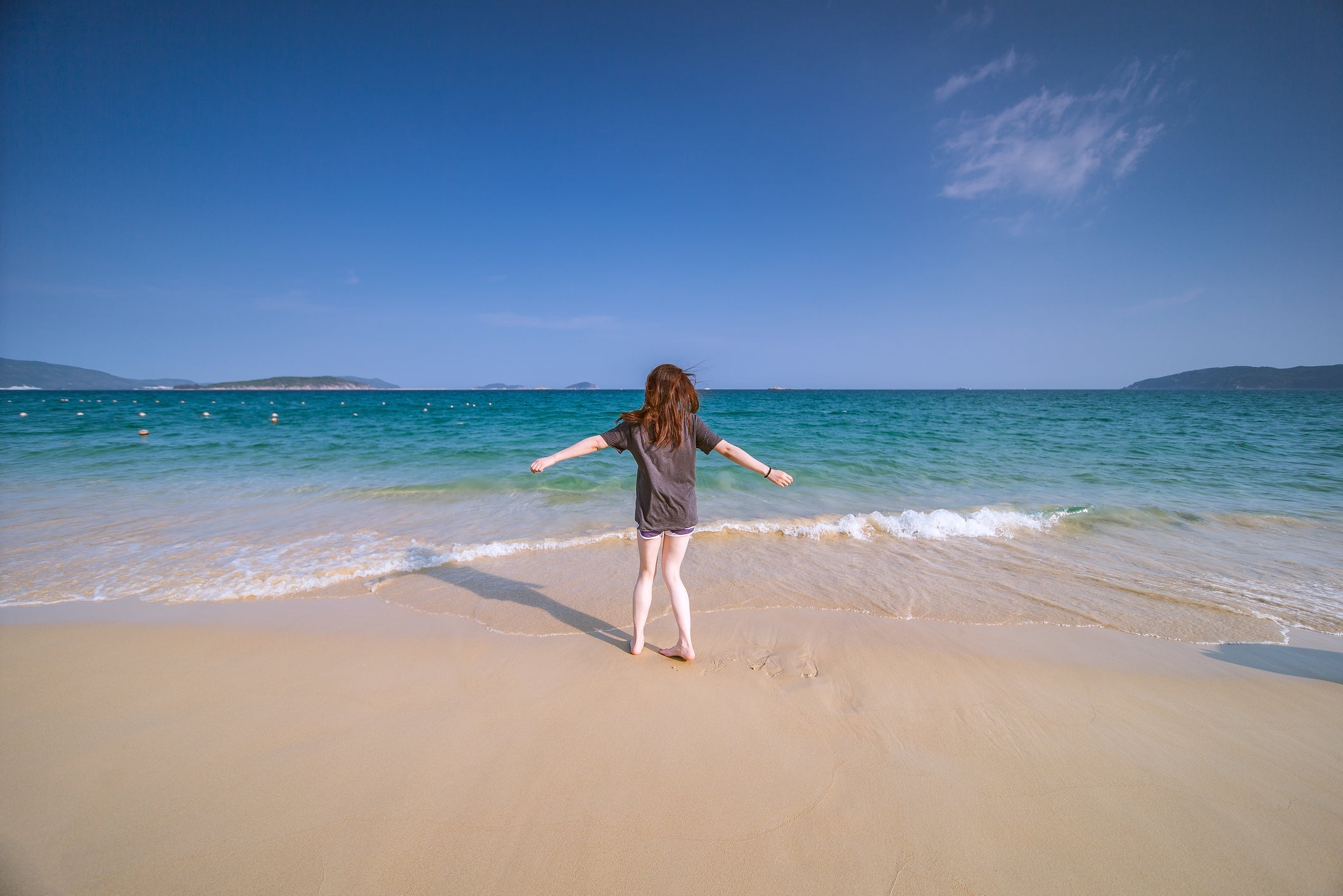 Young woman standing on the shore