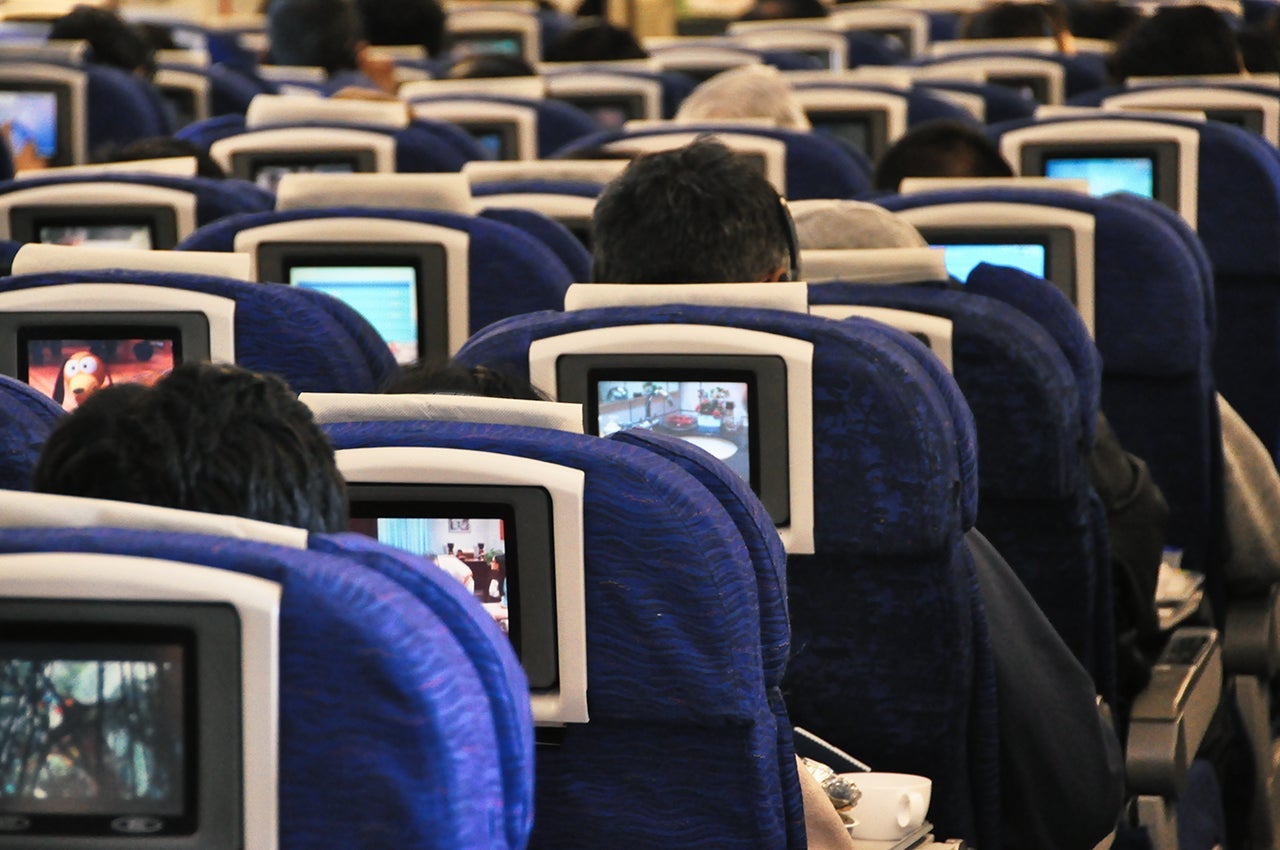 Rear View Of People Sitting In Airplane