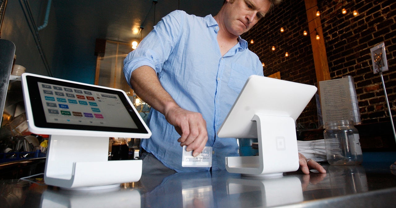 Matt Schodorf, owner of Schodorf's Luncheonette, swipes a credit card on the Square Stand at his re