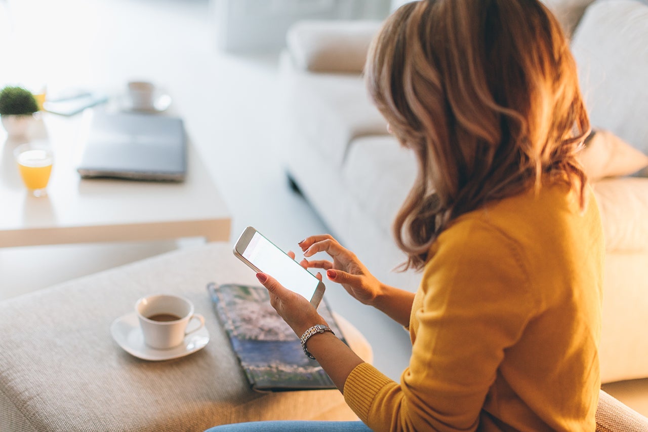 Young woman using smart phone at home