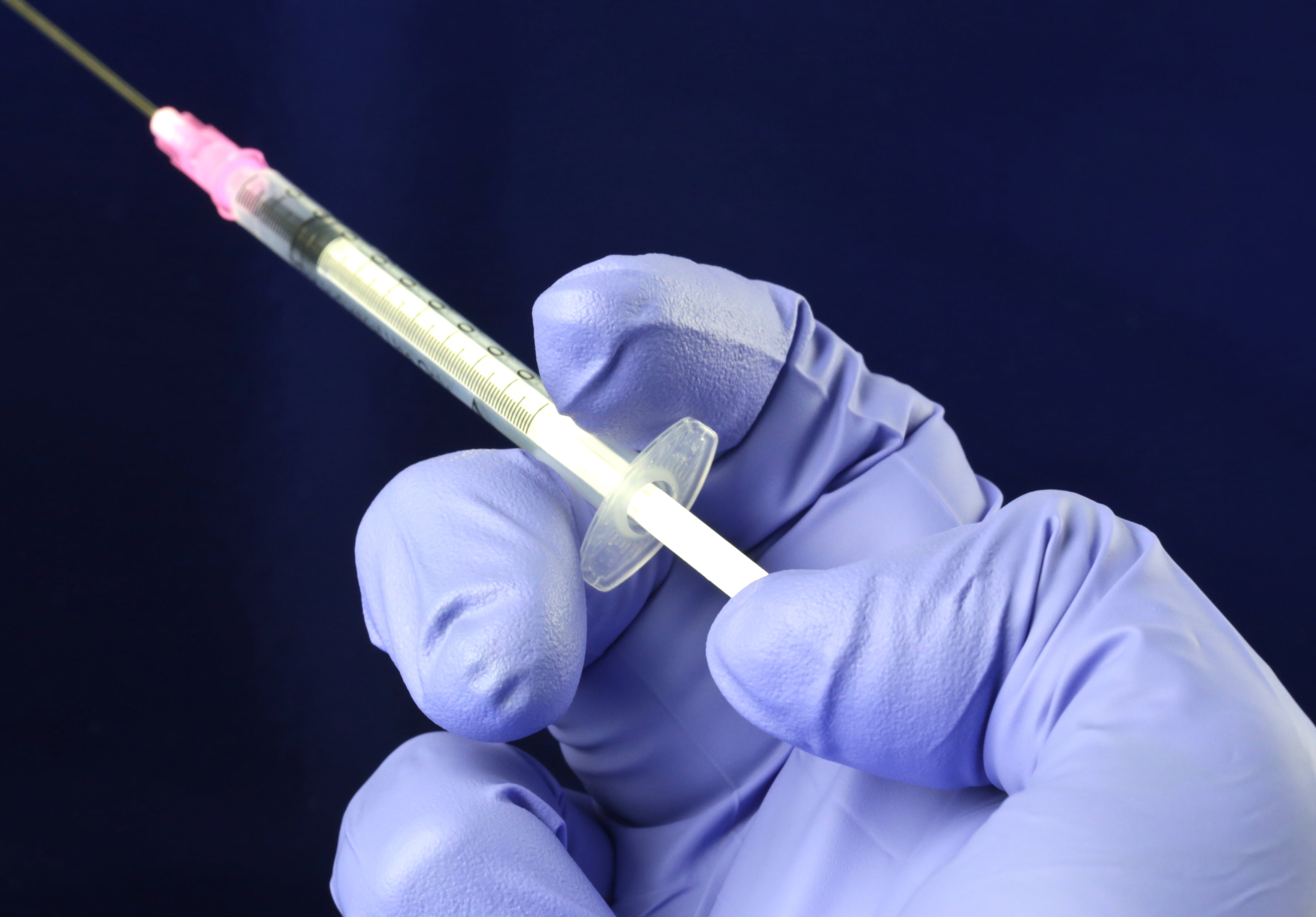 Health worker prepares a Hypodermic needle with Influenza vaccine