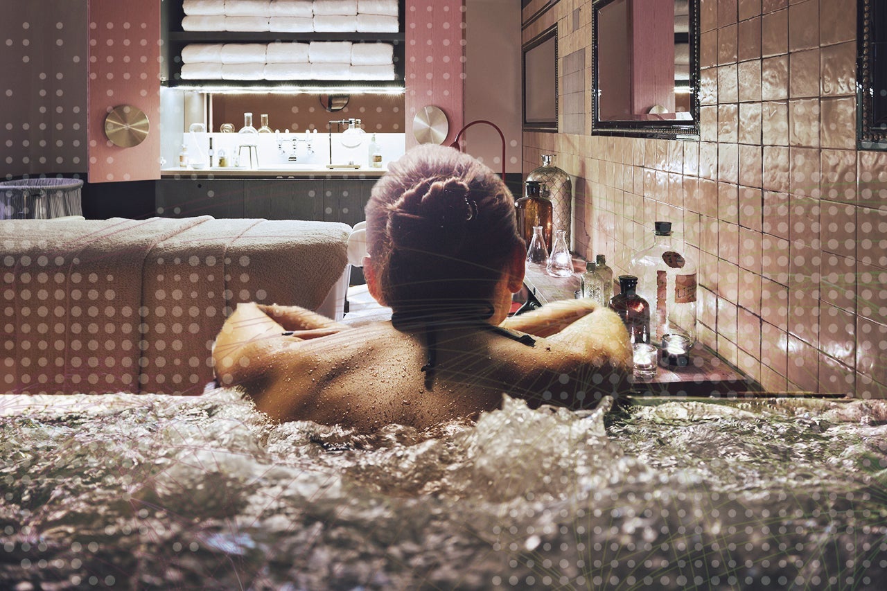 Woman relaxing in a jacuzzi pool during weekend days of relax and spa in a luxury place during travel vacations.