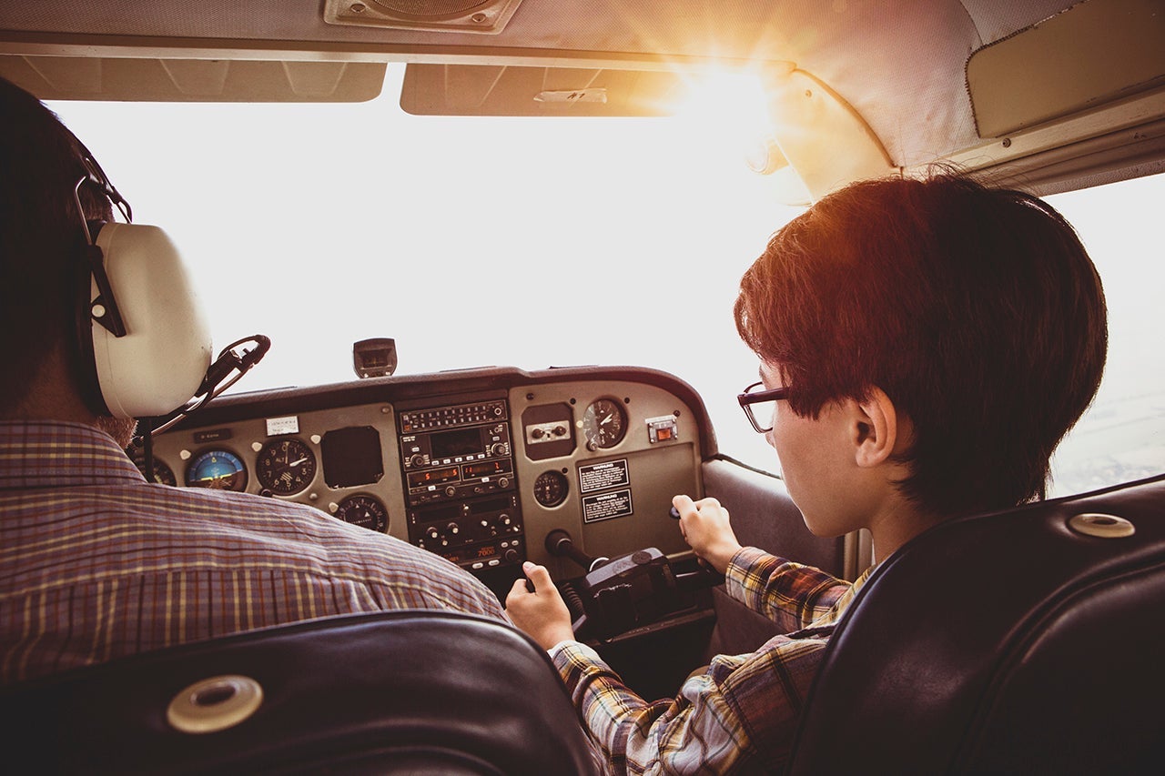 Father and son in cockpit of private airplane