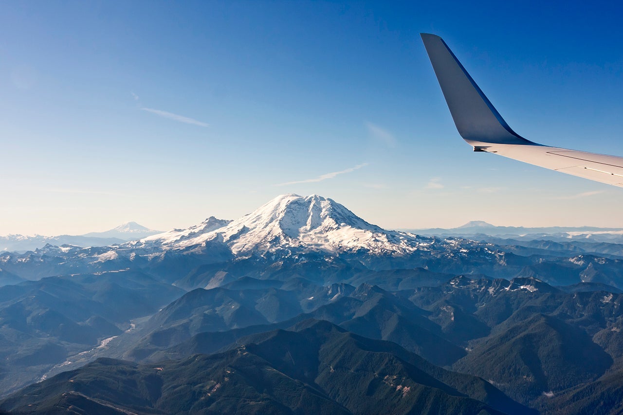Airplane Wing Crossing over the Mountains