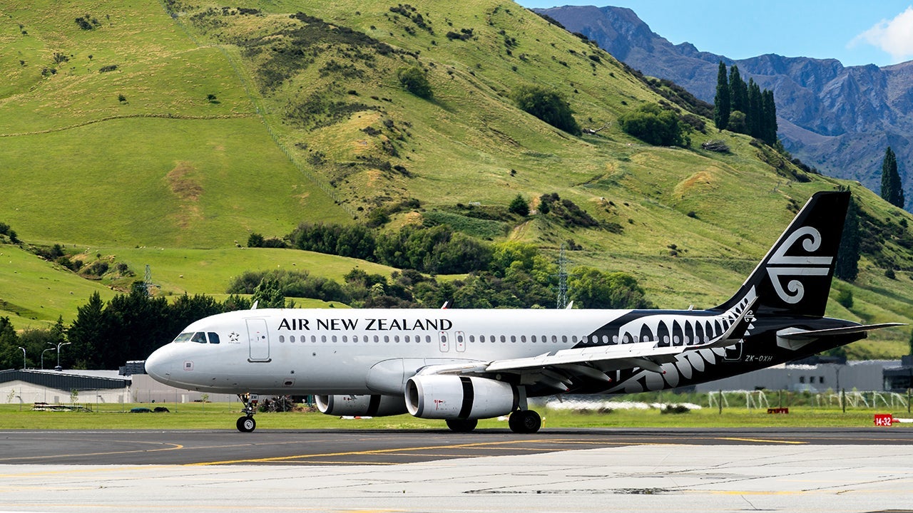 Airplane of Air New Zealand takes off from airport