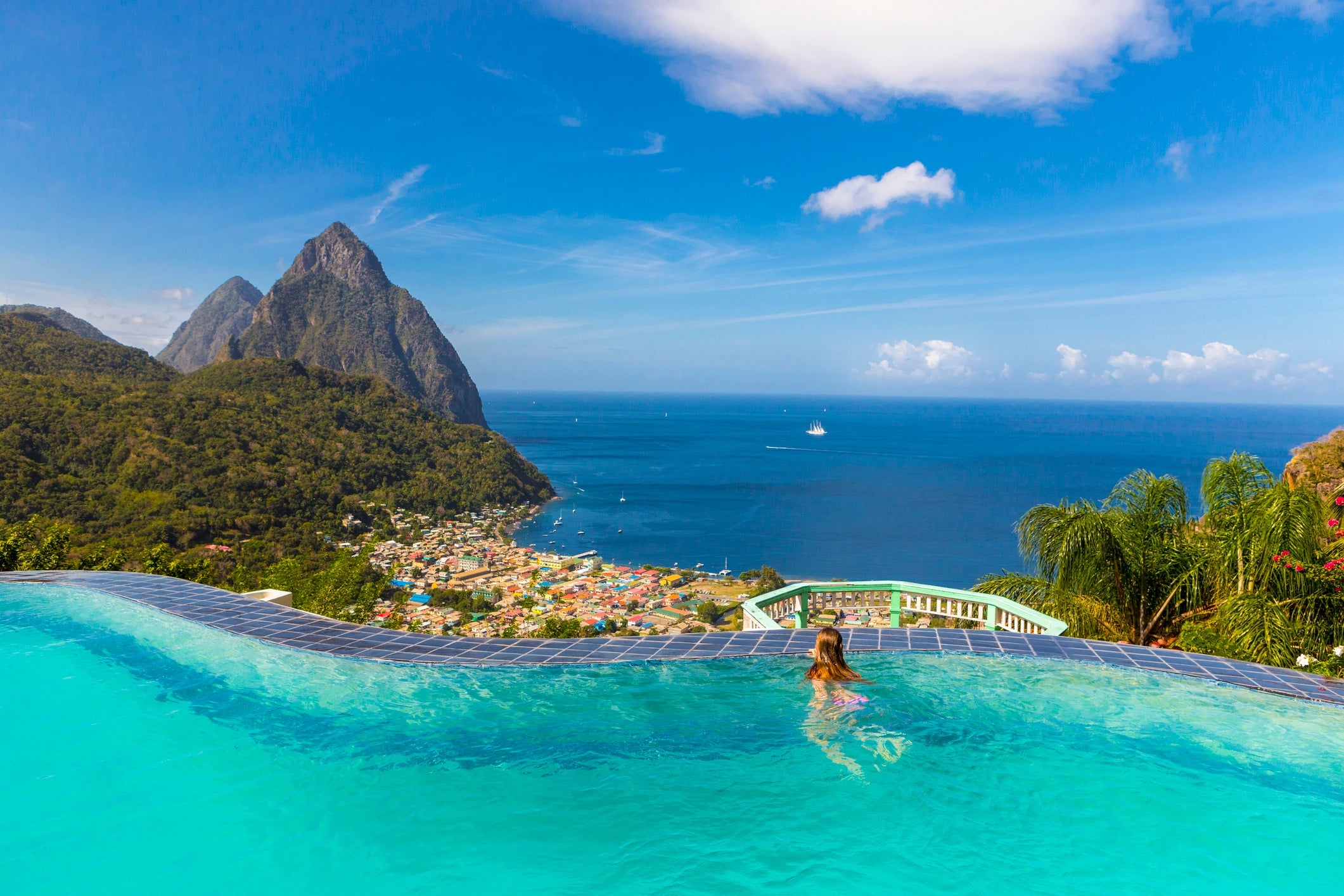 st. lucia - Caucasian girl swimming in infinity pool