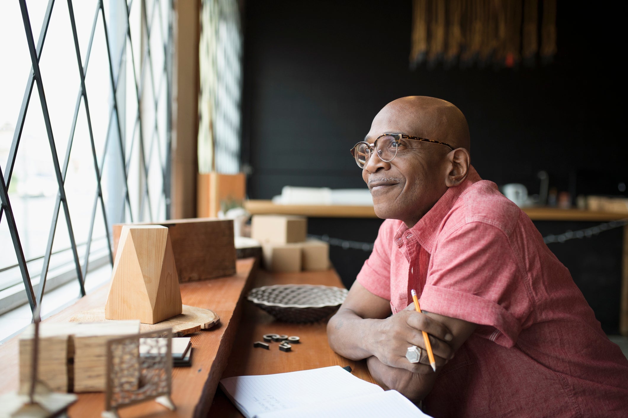 Pensive senior male entrepreneur looking out window