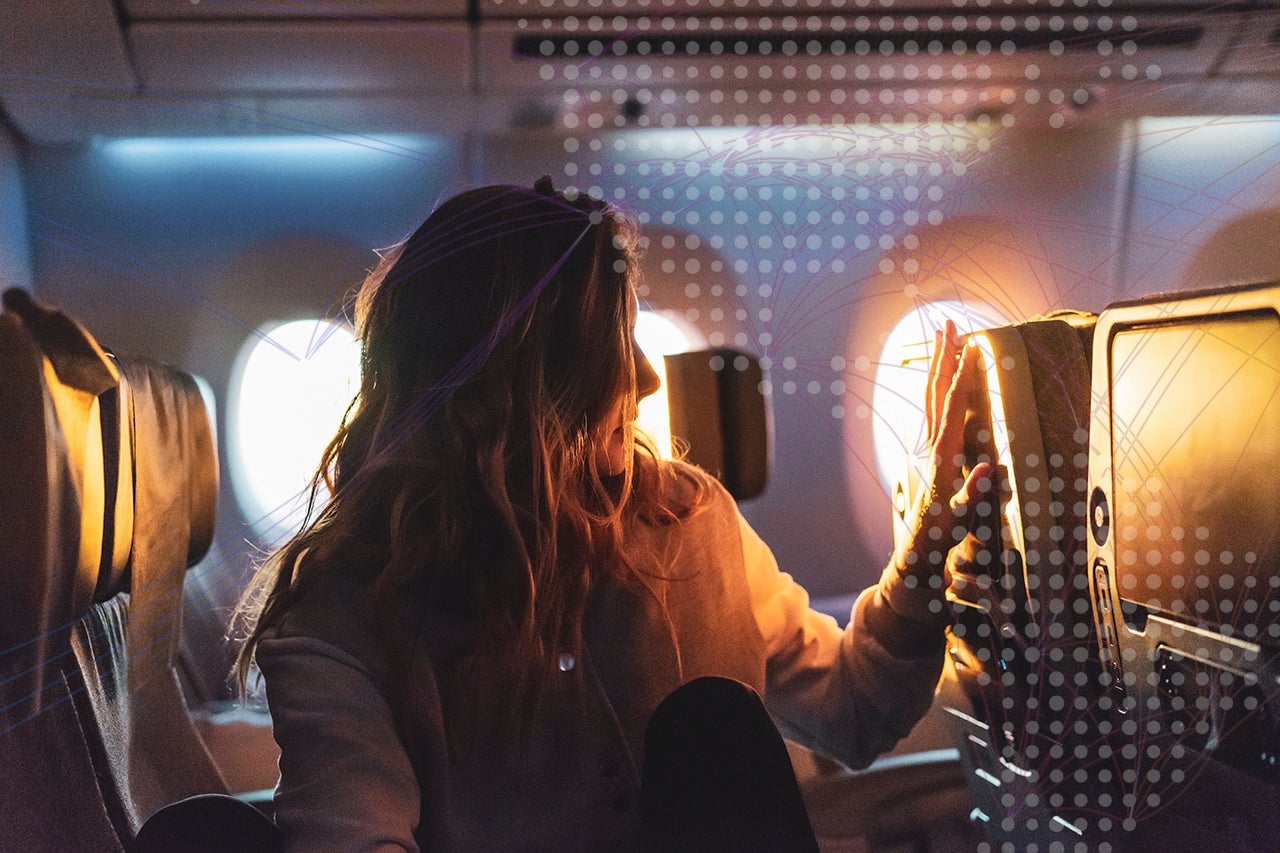 Young woman in plane at sunrise