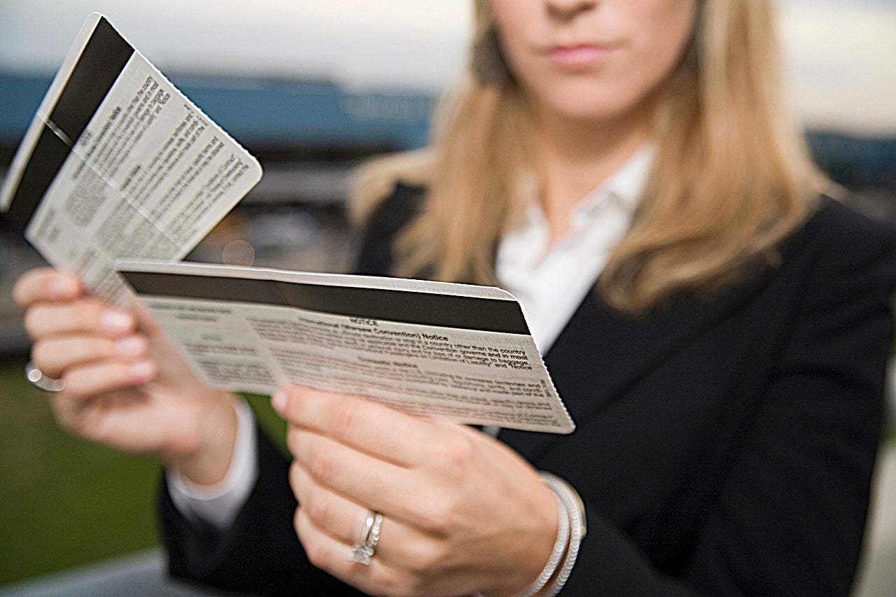 Woman reading airplane ticket
