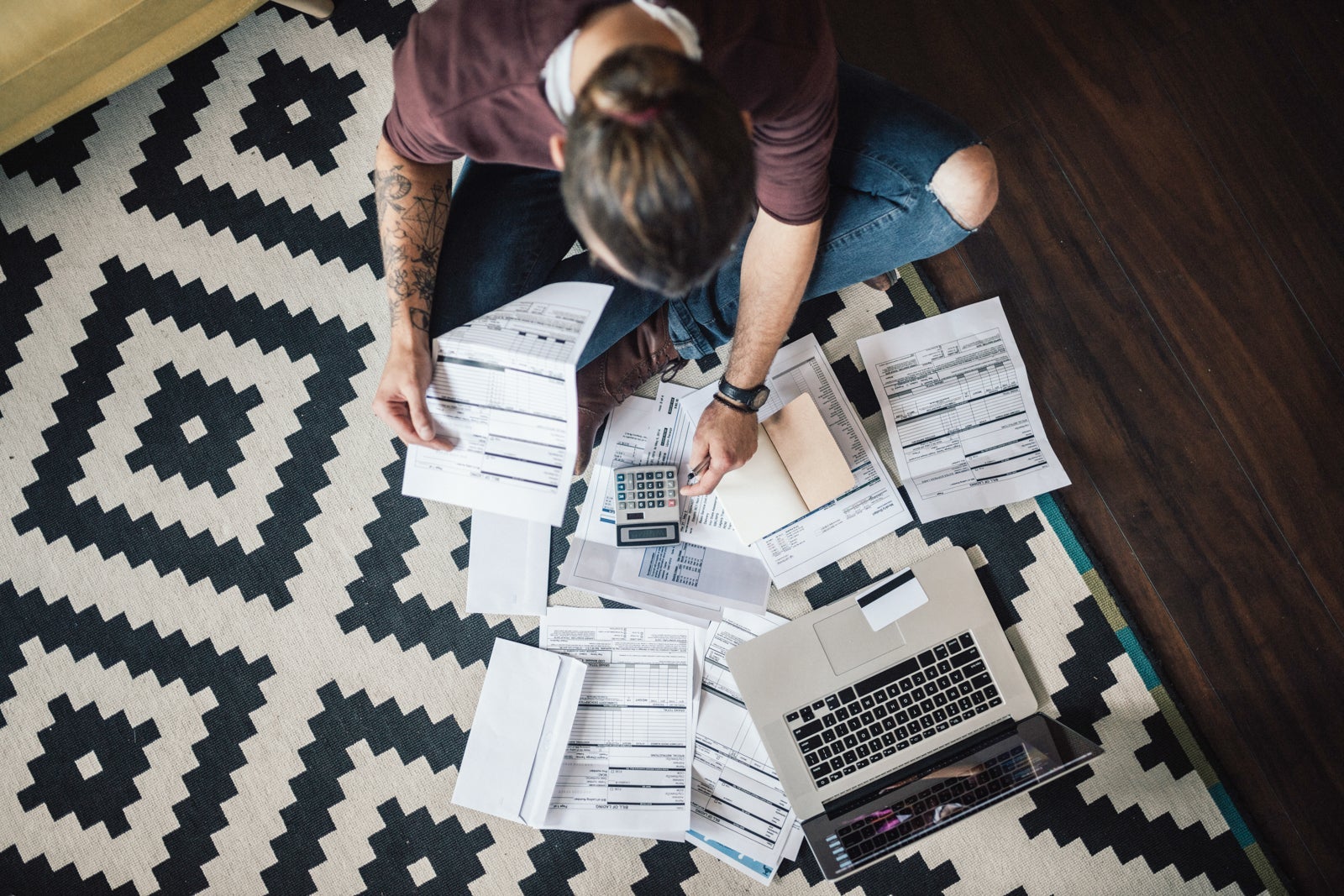 Top view on a student with bunch of overdue bills