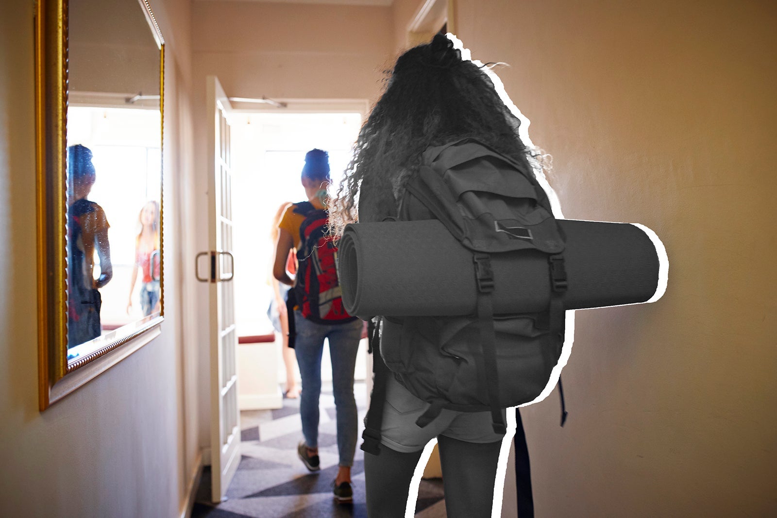 Young women with backpacks, walking on isle of youth hostel