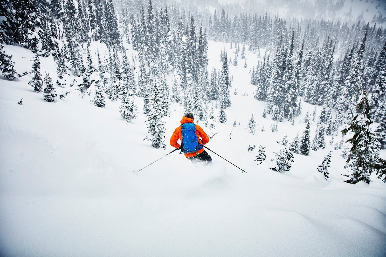 Man skiing though fresh snow while on backcountry ski tour