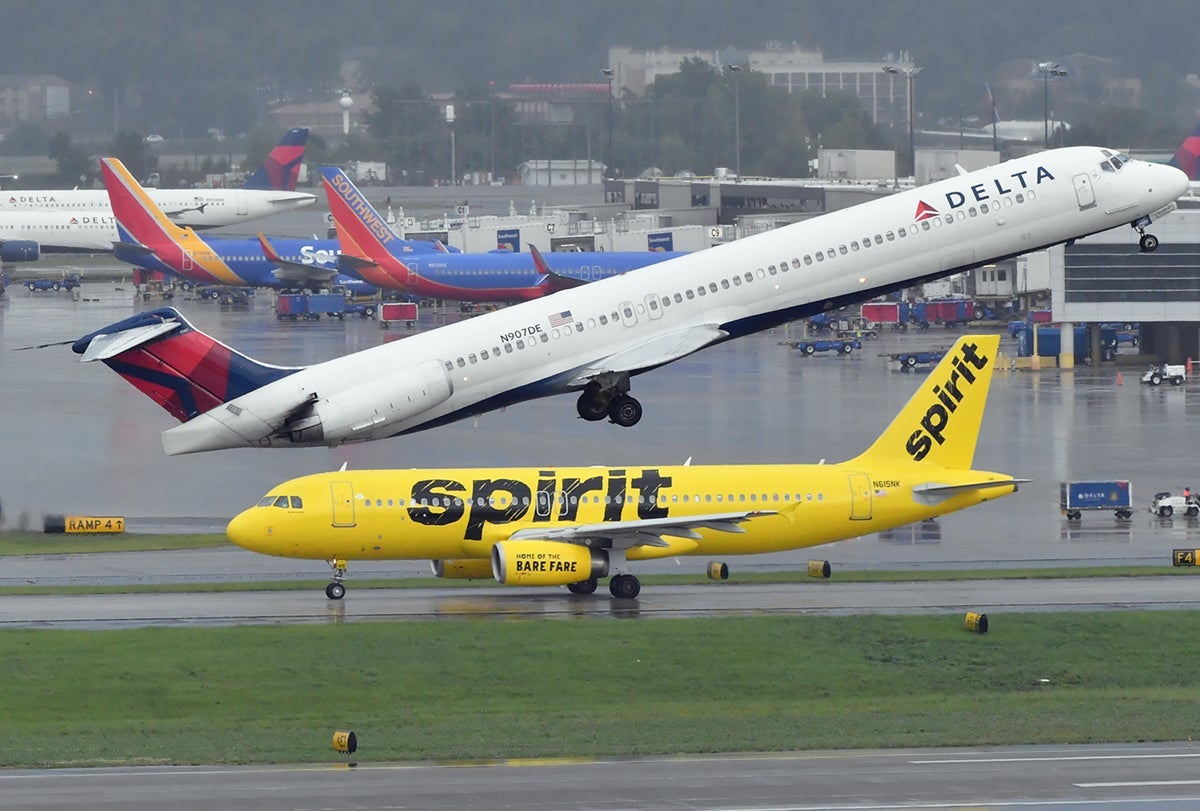 A Delta MD-88 taking off at Atlanta airport and a Spirit Airlines A320