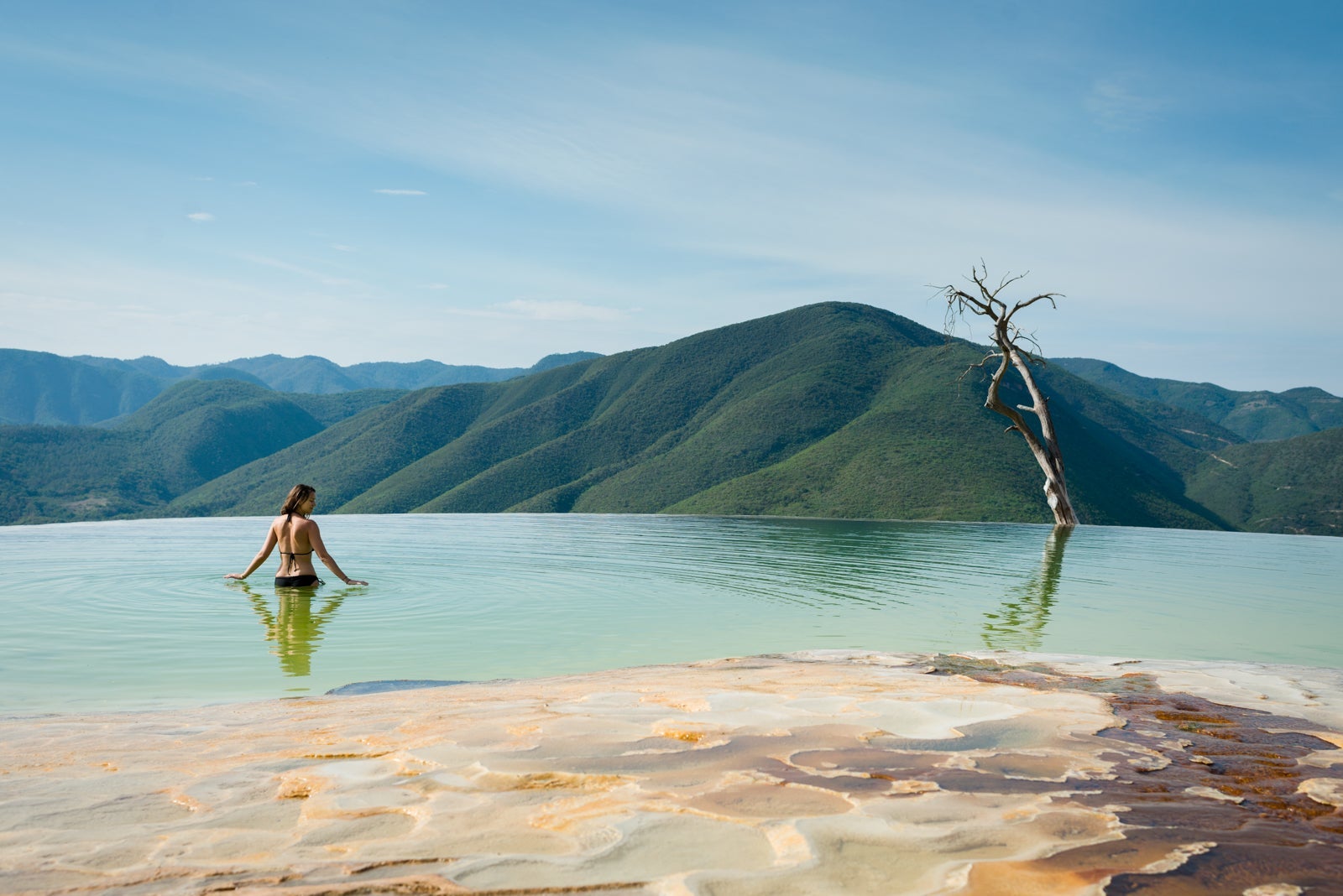 Woman relaxing in thermal spring, Hierve el Agua, Oaxaca, Mexico.