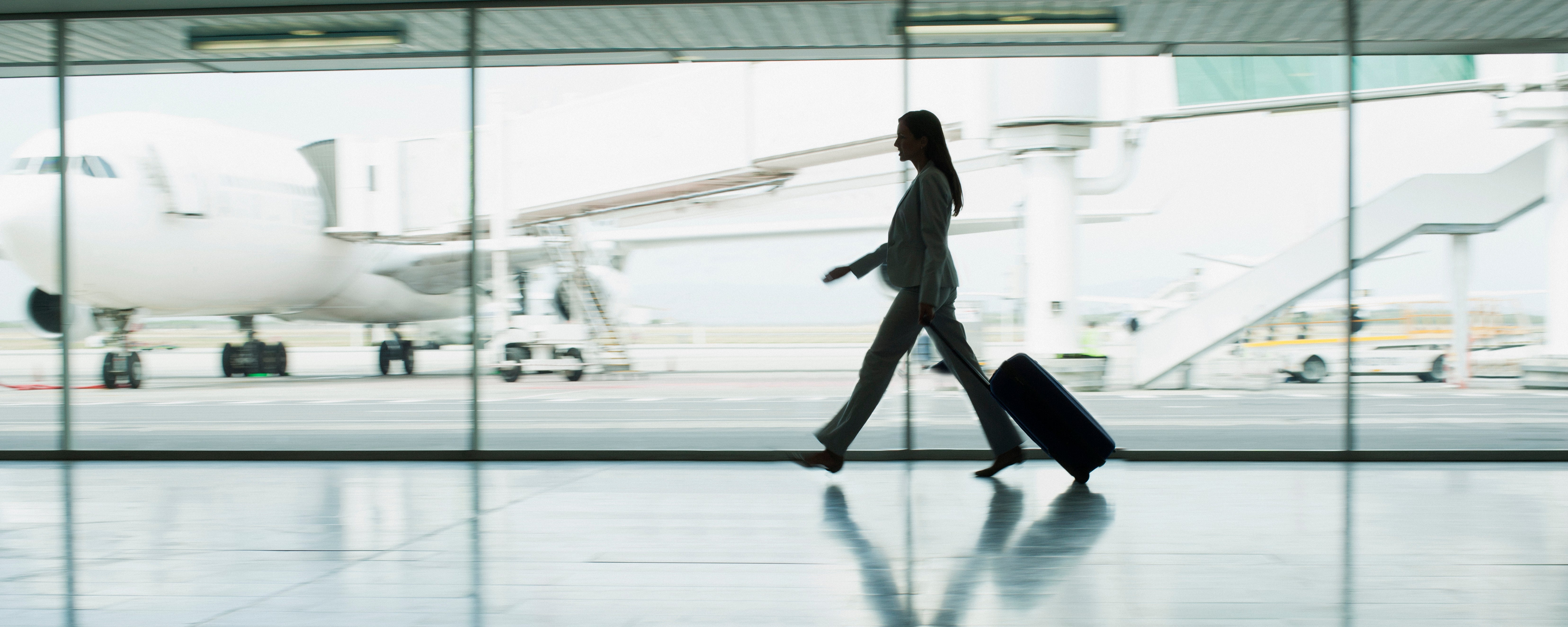 Businesswoman with suitcase in airport