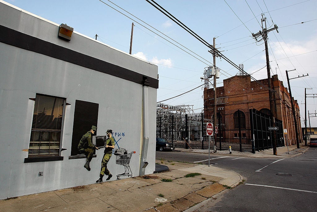Banksy Graffiti Murals Pop Up Around New Orleans, Including Levee Wall