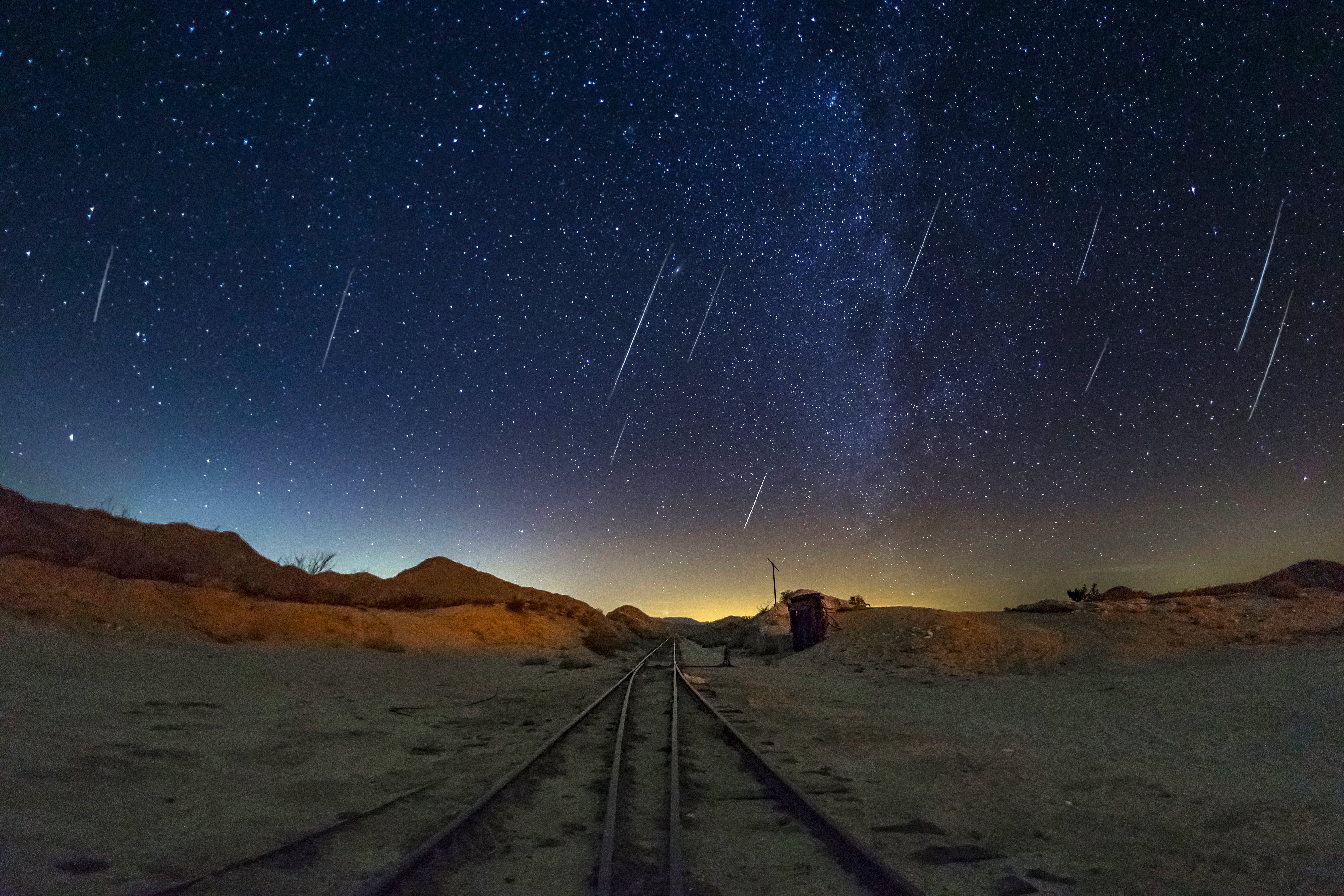Geminid Meteor Shower over trail tracks in the desert