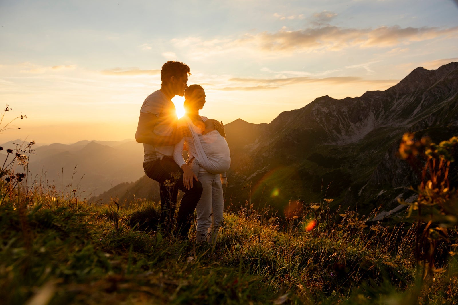 Germany, Bavaria, Oberstdorf, family with little daughter on a hike in the mountains at sunset