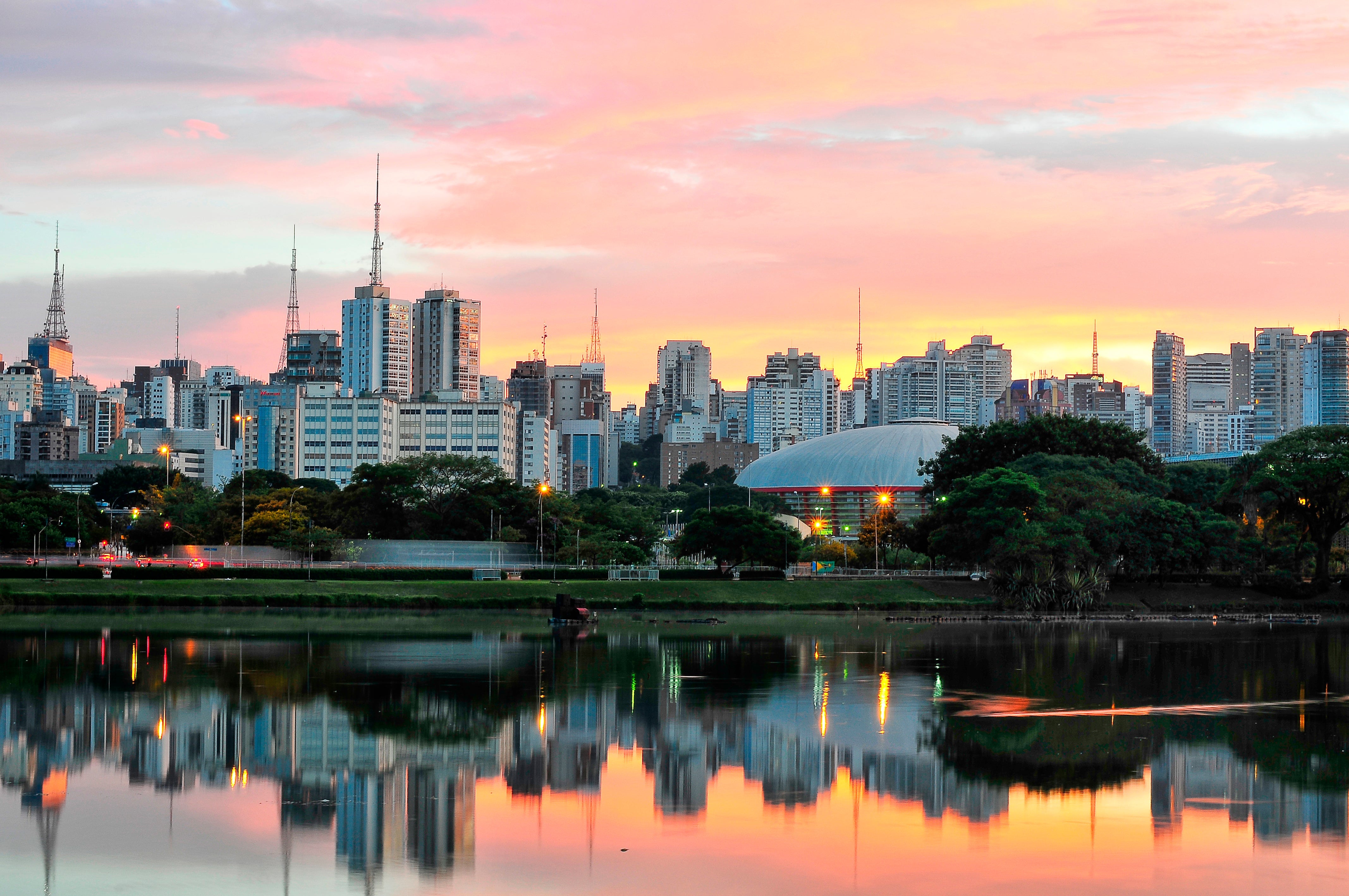 Skyline with reflections on lake at sunrise