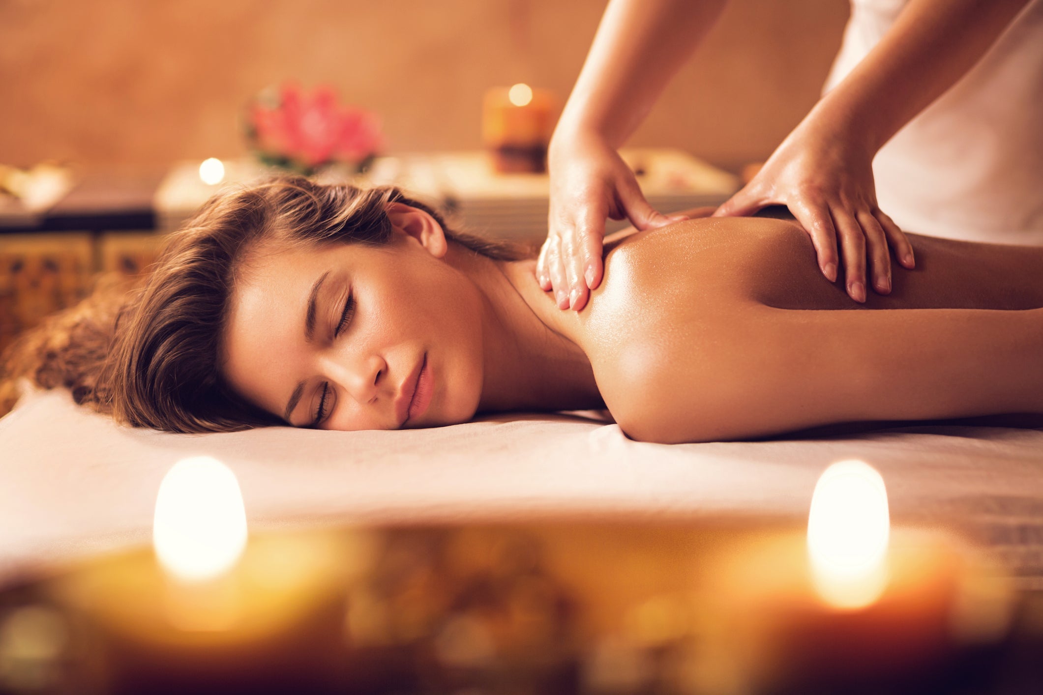 Young woman relaxing during back massage at the spa.